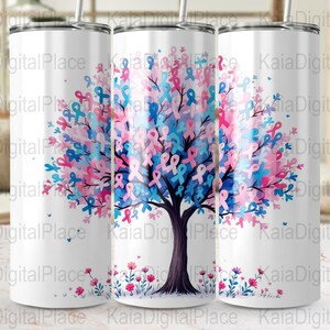 May include: White tumbler featuring a tree design with pink, blue, and purple ribbons. The tree has a dark brown trunk and branches, with a floral design at the base. The tumbler has a silver lid and straw.