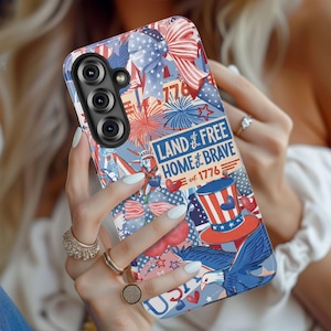 May include: A patriotic phone case featuring a design with red, white, and blue elements. The case includes fireworks, stars, and the text "Land of the Free, Home of the Brave" and "1776".