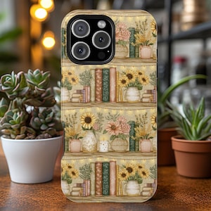 May include: A phone case featuring a repeating pattern of a bookshelf with sunflowers, books, and vases. The design includes warm yellow, green, and brown tones, with string lights adding a cozy feel. The case has a glossy finish.