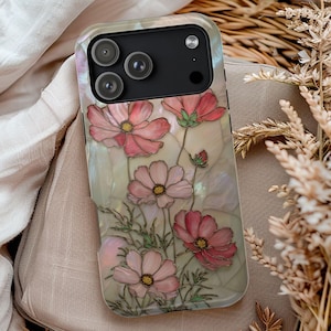 May include: A smartphone case featuring a floral design with pink cosmos flowers and green leaves. The case has a pearlescent background and a black camera module.
