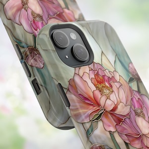 May include: A phone case with a floral design featuring pink peonies on a green and white background. The case has a camera cutout and a black border.