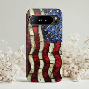 May include: A phone case featuring a stained-glass design of the American flag. The case has a red, white, and blue color scheme, with the stars and stripes of the flag prominently displayed. The case is designed to fit a smartphone.