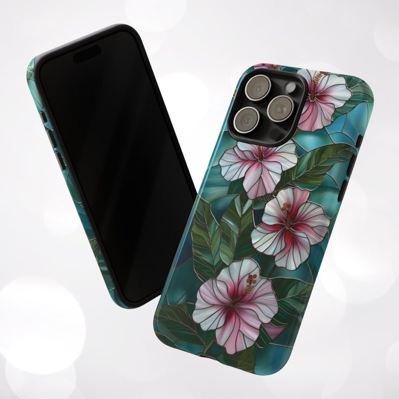 May include: A teal blue phone case with a stained glass design featuring pink and white hibiscus flowers. The case has a black border and a camera cutout.