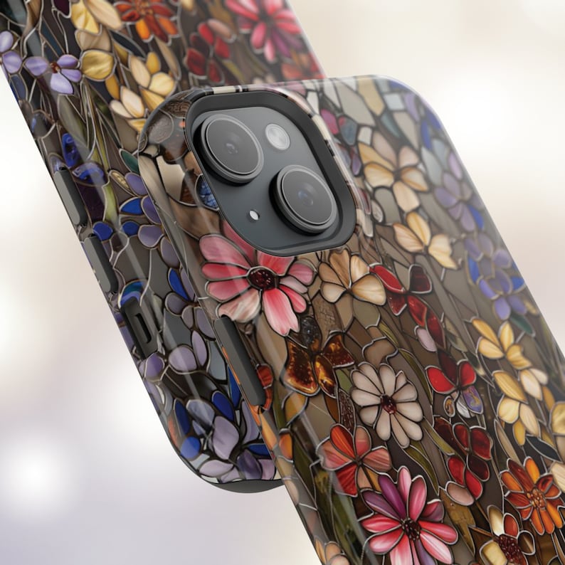 May include: A phone case with a stained glass design featuring colourful flowers and a butterfly. The case is black and has a camera lens cutout.