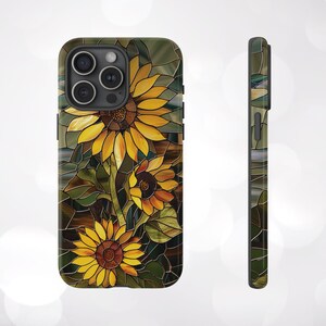 May include: A phone case with a stained glass design featuring sunflowers in shades of yellow, orange, and brown. The background is a dark green and brown mosaic.