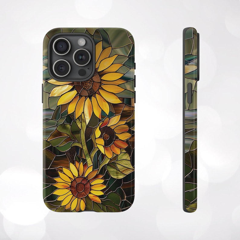 May include: A phone case with a stained glass design featuring sunflowers in shades of yellow, orange, and brown. The background is a dark green and brown mosaic.