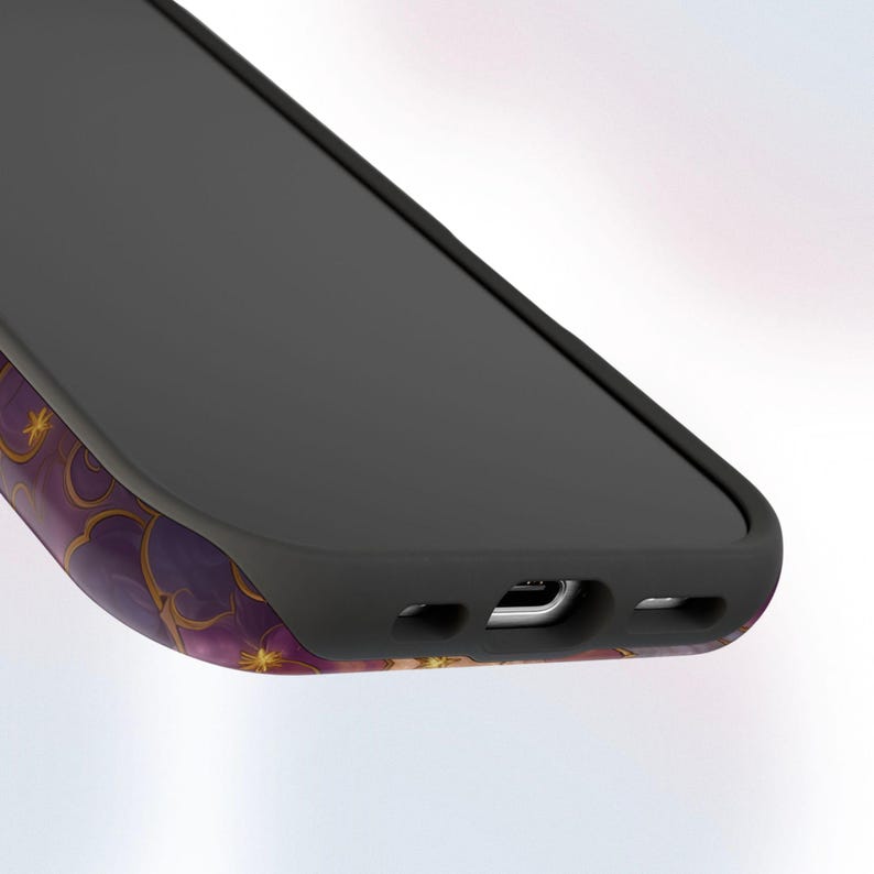 May include: A black smartphone with a purple and gold floral design on the side. The phone has a black screen and a black protective case. The design features gold stars and a repeating floral pattern.