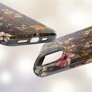 May include: Two phone cases featuring a floral design. The cases are black with a clear back that reveals a colourful stained glass style floral pattern.
