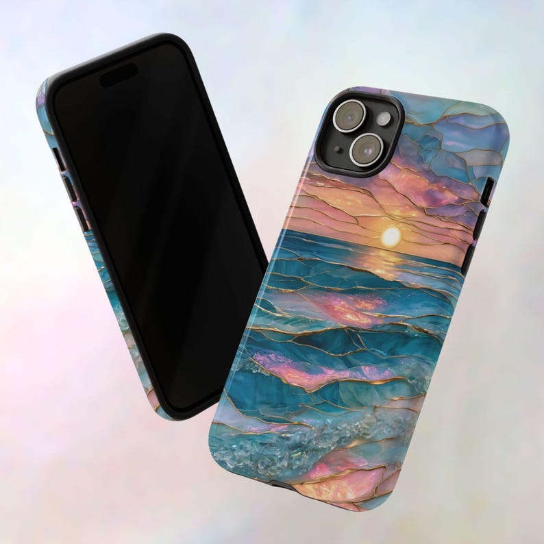 May include: A smartphone and a phone case with a sunset over the ocean design. The case features a vibrant depiction of the sun setting over the sea, with shades of blue, pink, and gold. The phone is black.