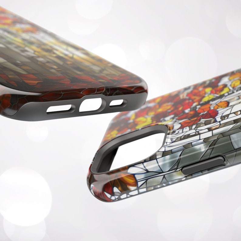 May include: Two phone cases with a stained glass design. The cases feature a colorful pattern of red, orange, yellow, and brown, with a black border. The design resembles a stained glass window with an autumn theme.