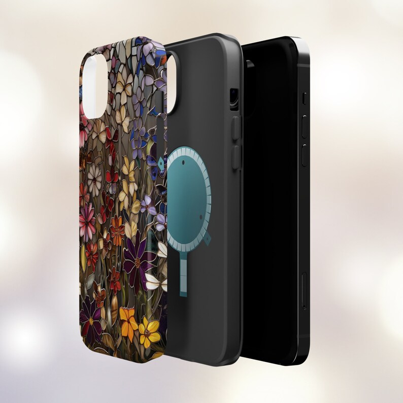 May include: A black phone case with a colourful floral pattern on the back. The case has a built-in magnetic ring holder.