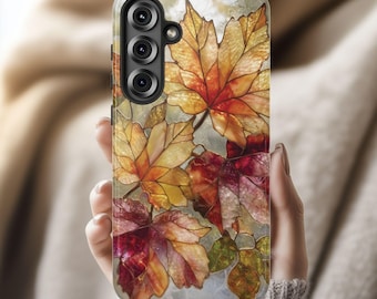 May include: A smartphone case with a stained-glass effect depicting autumn leaves in red, orange, and yellow. The case has a marble-like background and a triple-lens camera cutout.