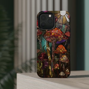 May include: A phone case with a stained glass design featuring colorful mushrooms. The case has a black background and a clear camera lens.