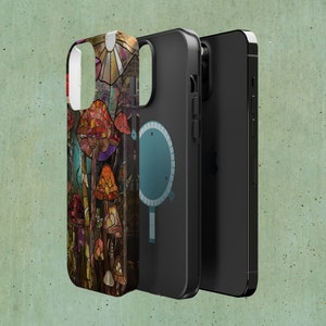 May include: A phone case with a colorful mushroom design. The case is made of a hard plastic material and has a clear back. The phone case is shown with a black phone case and a black phone.