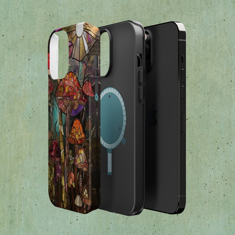 May include: A phone case with a colorful mushroom design. The case is made of a hard plastic material and has a clear back. The phone case is shown with a black phone case and a black phone.