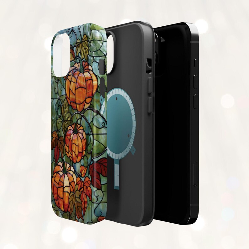 May include: A black phone case with a colorful stained glass design featuring pumpkins and leaves. The case has a built-in magnetic ring holder.