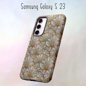 May include: A Samsung Galaxy S23 phone case with a pearlescent, fan-shaped pattern in shades of white, gold, and blue. The case has a glossy finish and a black camera housing. The text "Samsung Galaxy S 23" is at the top.