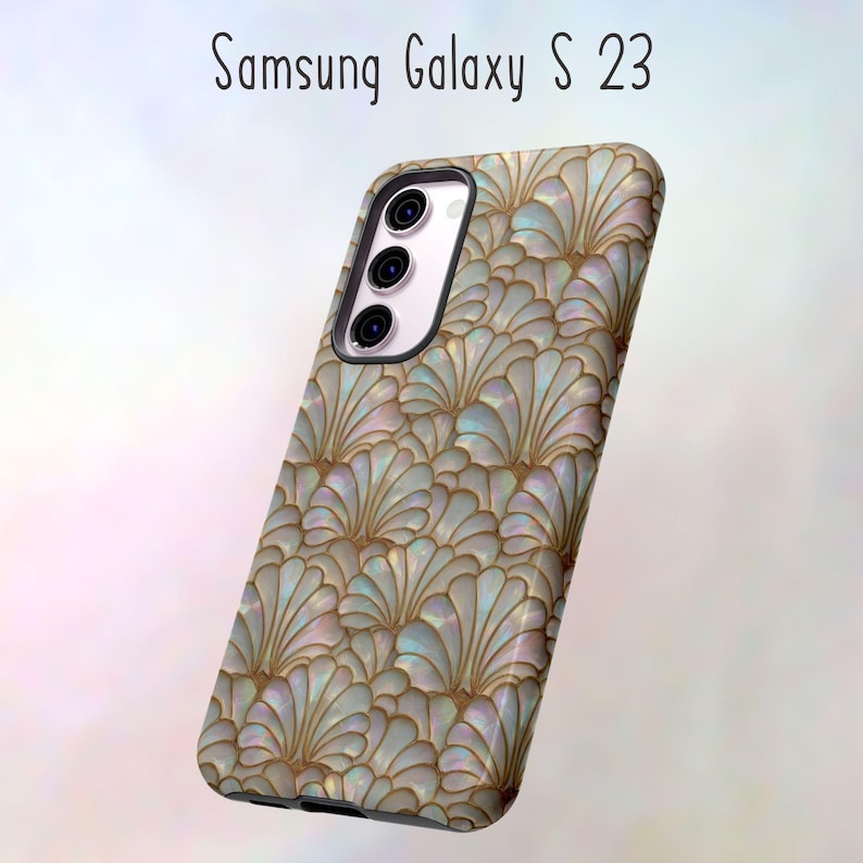 May include: A Samsung Galaxy S23 phone case with a pearlescent, fan-shaped pattern in shades of white, gold, and blue. The case has a glossy finish and a black camera housing. The text "Samsung Galaxy S 23" is at the top.