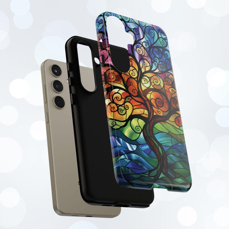 May include: A colorful phone case with a stained glass design of a tree with swirling branches. The case is black and has a cutout for the camera lens.