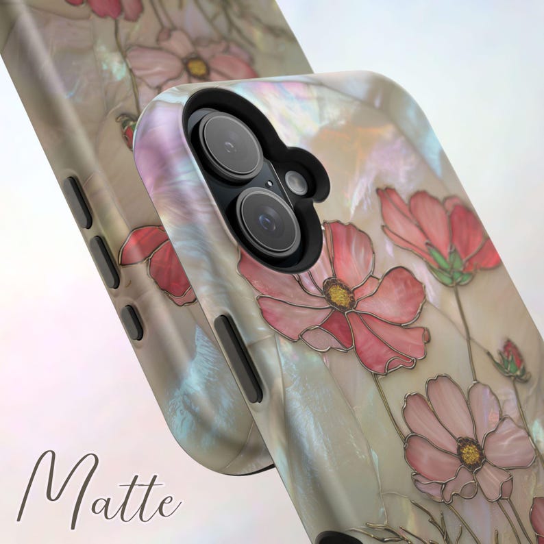 May include: Matte phone case with a floral design. The case features a pearlescent finish with pink flowers and green stems. The word "Matte" is printed in a cursive font on the bottom left corner of the case.