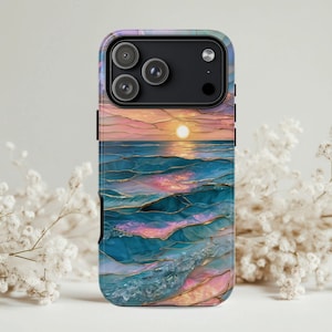 May include: A phone case featuring a sunset over the ocean. The design has a watercolor effect with shades of blue, pink, and gold. The case has a black border and a camera cutout.