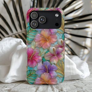 May include: A smartphone case featuring a vibrant floral pattern with hibiscus flowers in shades of pink, purple, orange, and yellow. The design includes green tropical leaves and gold-colored outlines, creating a stained-glass effect.