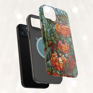 May include: A black phone case with a stained glass design featuring orange pumpkins and green leaves.
