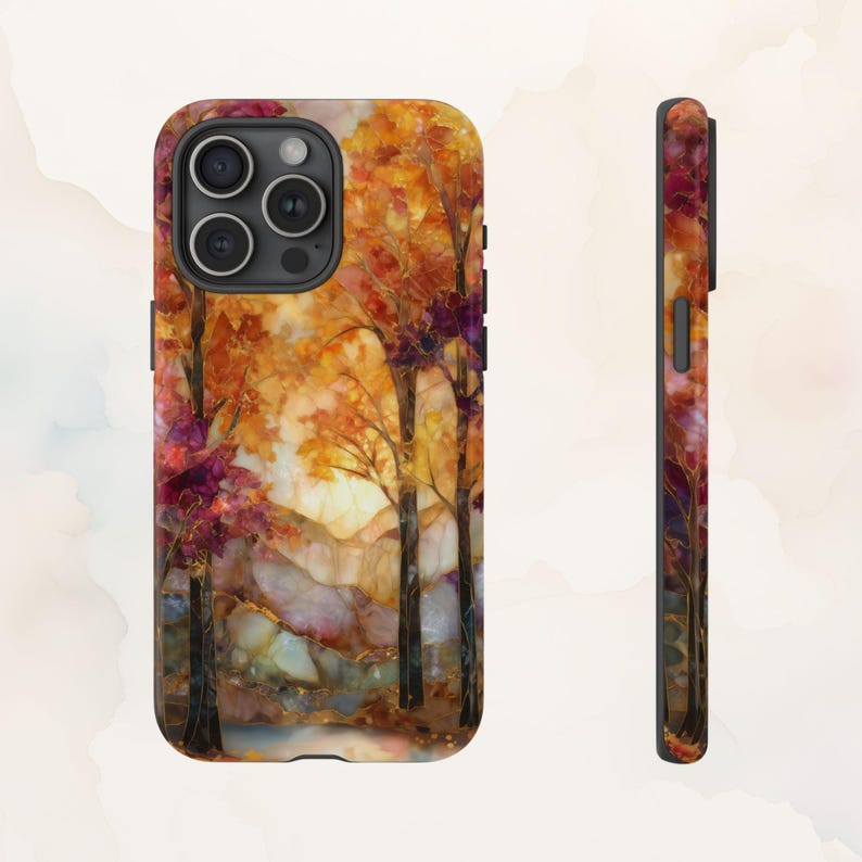 May include: A phone case featuring a vibrant autumn landscape. The design showcases trees with orange and red foliage, a light-filled sky, and a hint of a stream. The case's side also displays the colorful design.