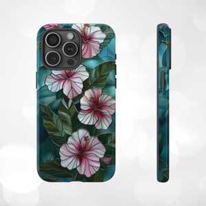 May include: A phone case with a stained glass design featuring pink hibiscus flowers on a teal background.