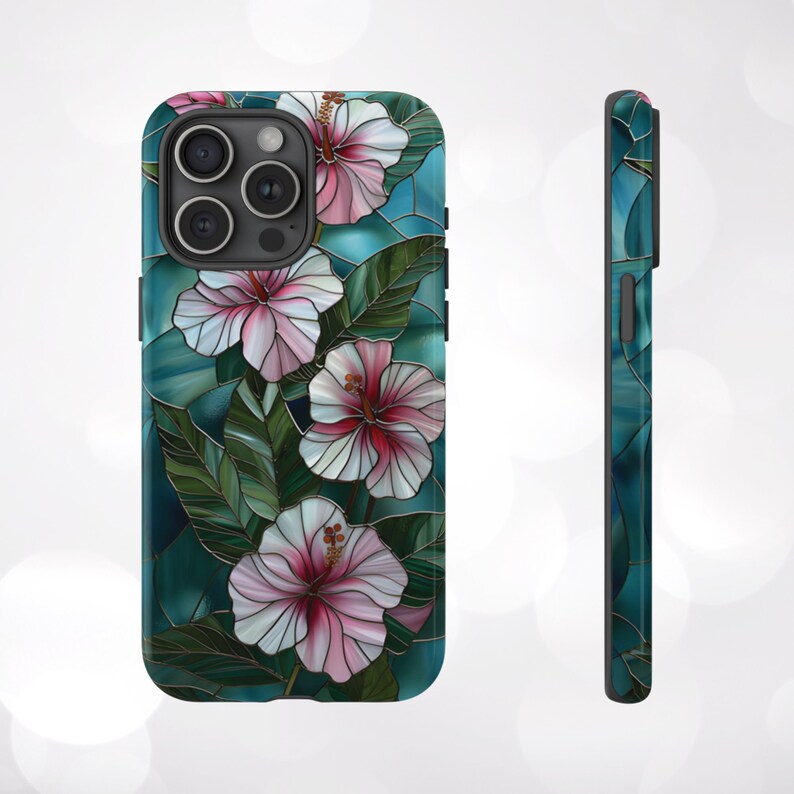 May include: A phone case with a stained glass design featuring pink hibiscus flowers on a teal background.