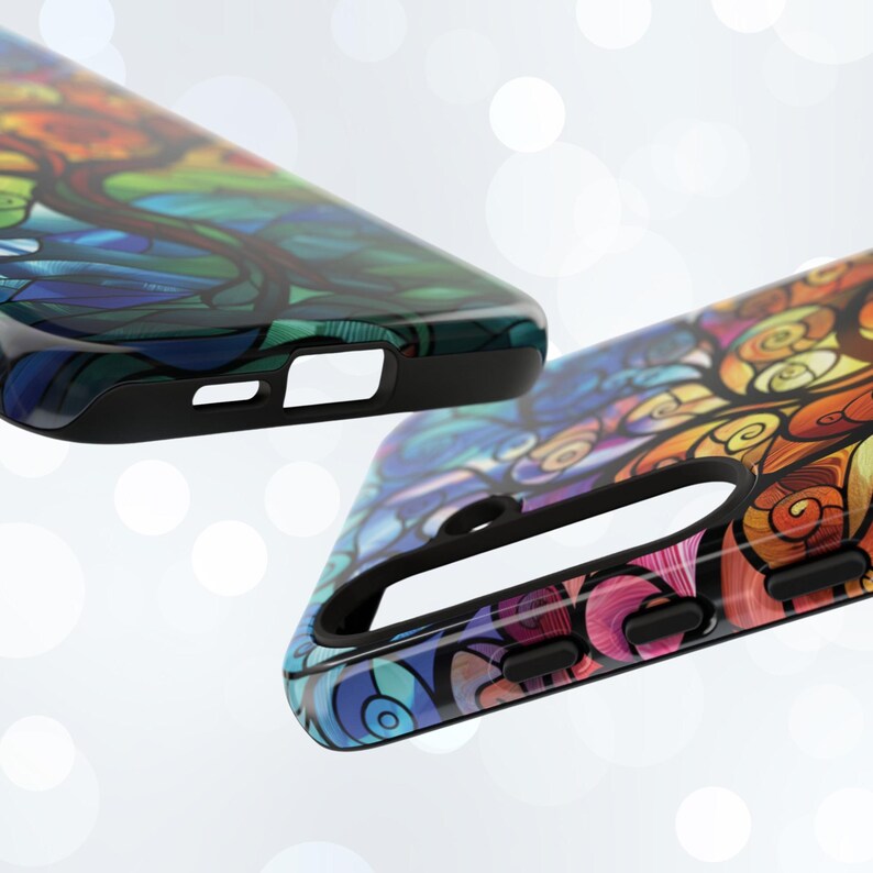 May include: Two colorful phone cases with abstract designs. The cases are black with a glossy finish and feature vibrant colors and swirling patterns.
