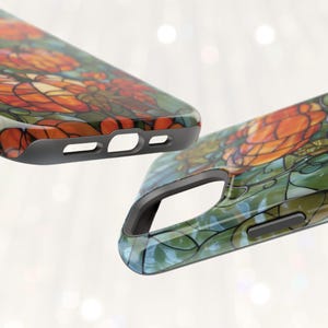 May include: A phone case with a stained glass design featuring orange, blue, and green colors. The case has a black border and cutouts for the camera and buttons.