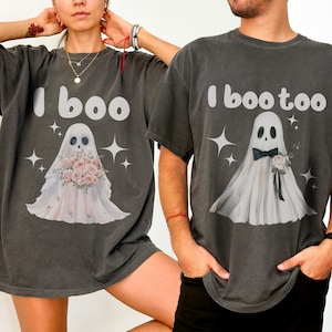 May include: Two grey t-shirts with a ghost graphic and the text "I boo" and "I boo too".