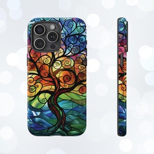 May include: A colorful phone case with a stained glass design of a tree with swirling branches and leaves. The background is a blue and green stained glass pattern.