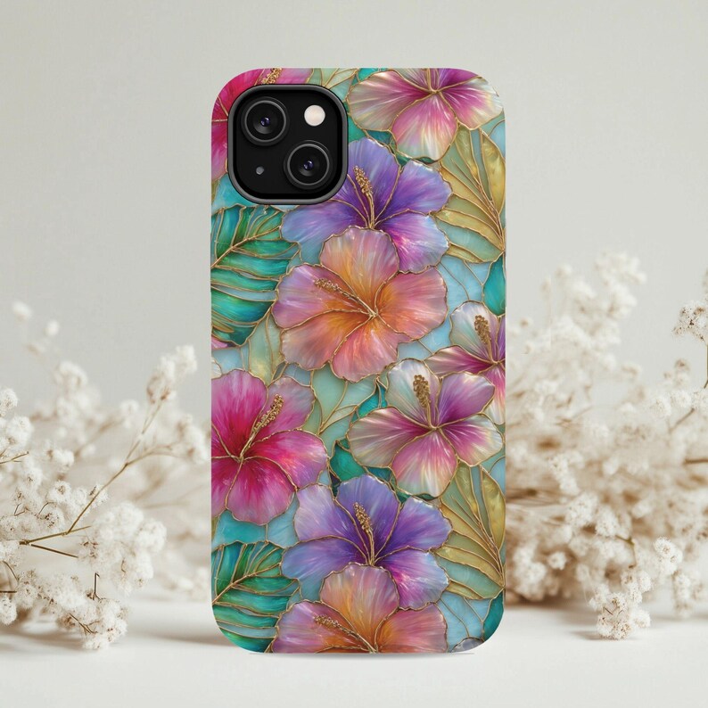 May include: A phone case featuring a stained glass style pattern of vibrant hibiscus flowers in shades of pink, purple, and orange, interspersed with teal and green leaves. The design includes thin gold outlines separating each petal and leaf segment.