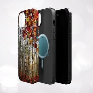 May include: A set of three phone cases. The first case features a stained-glass design of autumn leaves in shades of red, orange, and yellow. The second case is black with a teal graphic. The third is a black phone.