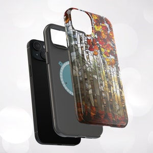 May include: Three phone cases. The first is black, the second is gray with a blue and white graphic, and the third features a stained-glass design of autumn trees with red, orange, and yellow leaves. The cases are designed to protect the phone.
