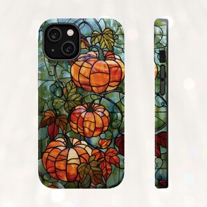 May include: A stained glass style phone case with a design of orange pumpkins on a green vine.