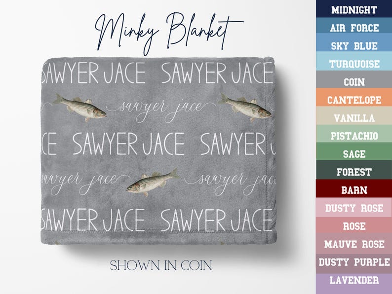 May include: A grey minky blanket with the words "Sawyer Jace" in white, repeated across the surface. The blanket features fish illustrations and the text "Minky Blanket". The colour is shown in "Coin".