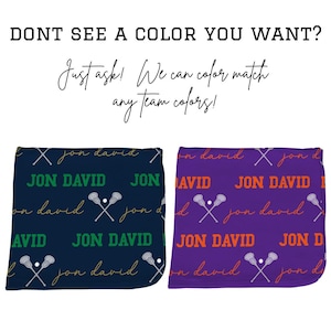 May include: Two personalized lacrosse blankets, one navy blue with green and gold text, the other purple with orange and white text. Each features the name "Jon David" and lacrosse stick graphics. Text at the top reads "DONT SEE A COLOR YOU WANT?" and "Just ask! We can color match any team colors!"