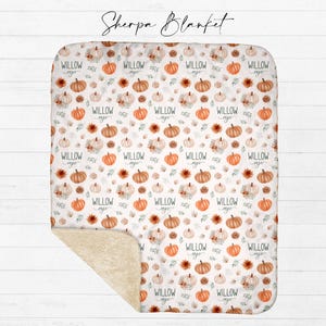 Personalized fall pumpkin sherpa blanket with ivory sherpa backing showing watercolor pumpkin and floral design with custom name from Twinklette
