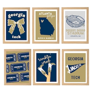 May include: Six framed prints with a light wood finish. The prints feature Georgia Tech themes, including a bow, the state of Georgia, a stadium, tickets, cowboy boots, and a pennant. Each print has a navy blue, gold, and white color scheme.