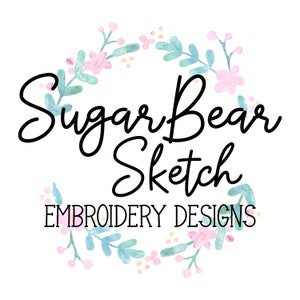 May include: A watercolor floral wreath with pink and blue flowers and green leaves. The text "Sugar Bear Sketch Embroidery Designs" is in the center of the wreath.