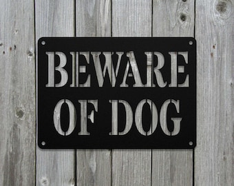 May include: Black metal sign with white lettering that reads "BEWARE OF DOG".