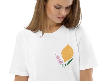 May include: A white t-shirt with a yellow lemon and pink flowers graphic print.
