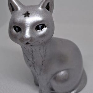 Mystical silver cat made of concrete?