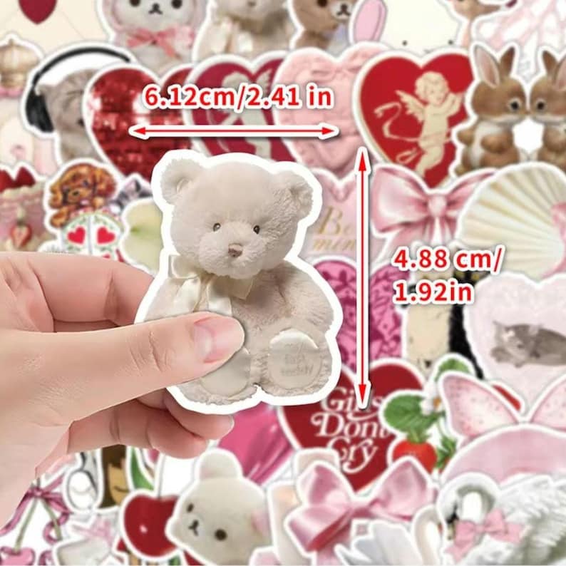 May include: A sheet of stickers featuring a variety of cute designs, including a teddy bear, hearts, bows, and a bunny. The stickers are approximately 2.41 inches wide and 1.92 inches tall.