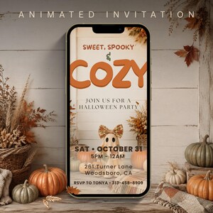 May include: A smartphone displaying an animated Halloween party invitation with the text SWEET, SPOOKY & COZY, JOIN US FOR A HALLOWEEN PARTY, SAT OCTOBER 31, 5PM-12AM, 261 Turner Lane, Woodsboro, CA, and RSVP TO TONYA 313-458-8909 above a ghost graphic.