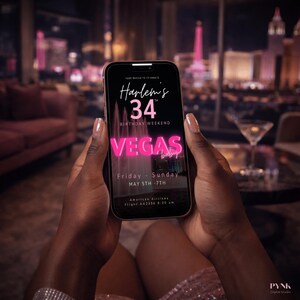 Animated Vegas birthday invitation displayed on iPhone held in hands at rooftop lounge overlooking Las Vegas Strip. Pink neon “Vegas Baby” text with custom name and age. Digital phone invitation template editable in Canva. Modern birthday weekend trip invite for girls getaway, milestone birthday, or luxury Las Vegas celebration.