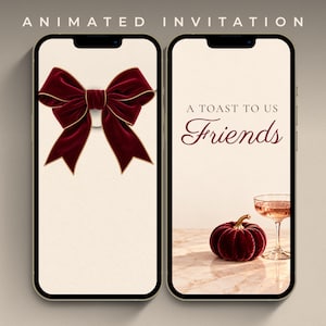 May include: Two smartphones displaying an animated invitation. The left screen shows a large dark red velvet bow with gold trim. The right screen features the text A TOAST TO US Friends, a dark red velvet pumpkin, and a glass of pink champagne.